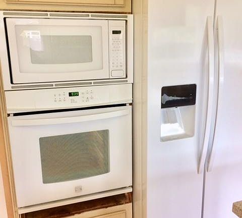 Newer double oven with newer refrigerator.