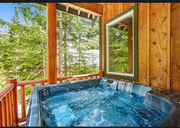 Hot tub on deck with access to main living room and primary suite