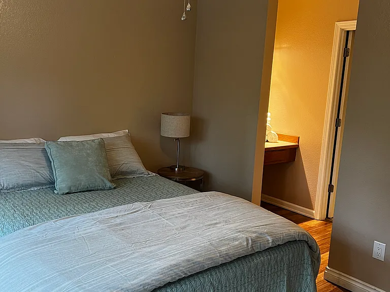primary bedroom with vanity and second entrance to bathroom