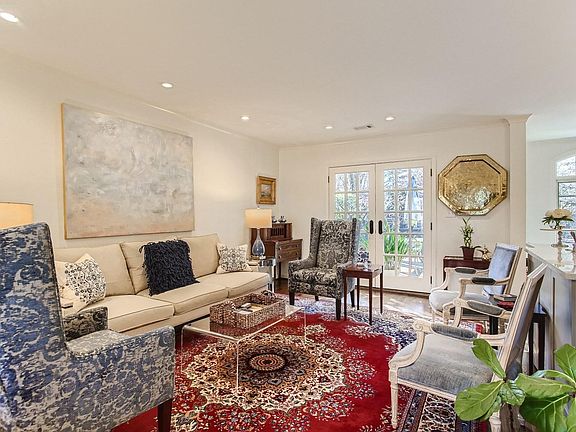 The great room with French doors onto deck is open to the kitchen for inclusive entertaining.