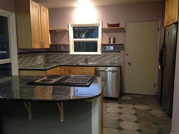 Entrance door from driveway. Electric stove shown has been replaced with smooth top and overhead range hood.
