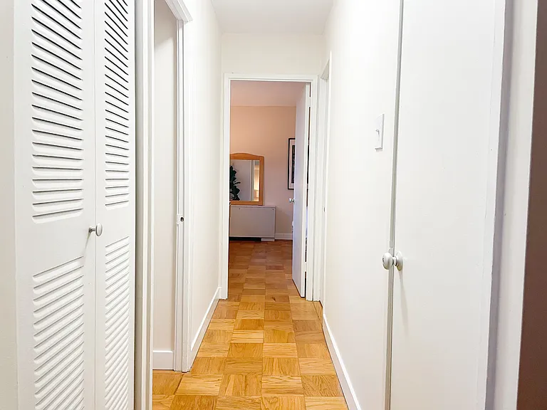 Hallway from living room towards bathrooms and bedrooms