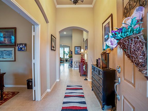 You are greeted by an abundance of architectural details, arched entry way to the living area of the home, French doors to the study / home office.