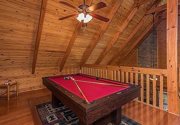 Vaulted gameroom with pool 