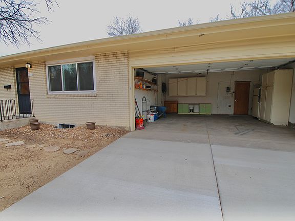 2 Car Garage with lots of Storage Cabinets and Shelving