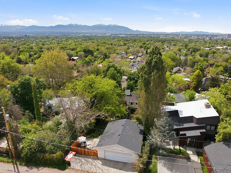 Huge 4 car garage with work bench accessible from the back alley. Additional 2 covered garage spaces in the front of the house. Mature trees throughout the lot give lots of shade on hot sunny days.
