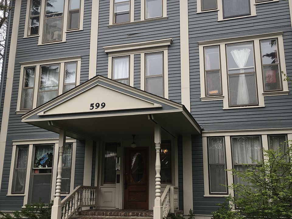 Front of property. Shares 3rd lot with building next door. Dedicated extra-deep garage. Secured fencing surrounds all three lots. Peace and security while enjoying the outdoors in the shared lot.