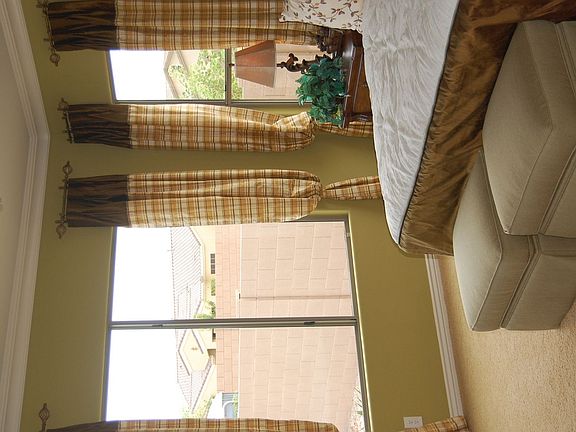 west side of master bedroom, has faux brown wooden blinds today