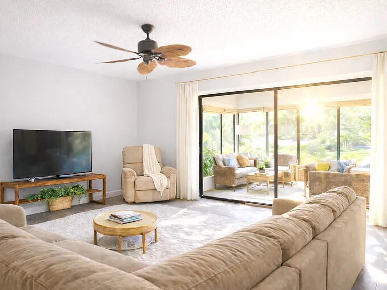 Beautiful Spacious Living Room. Open floor plan with the Dinning Room. Huge Sliding Glass Doors opens up to the Sunroom.
