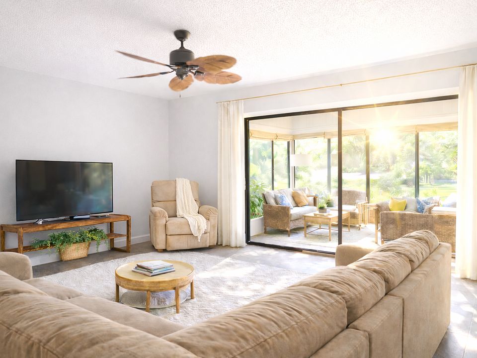 Beautiful Spacious Living Room. Open floor plan with the Dinning Room. Huge Sliding Glass Doors opens up to the Sunroom.