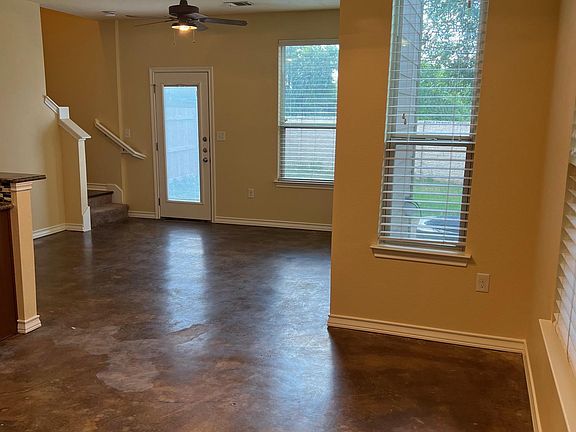 Walk through the front door and view the large living area with concrete floors and plenty of windows with adjustable blinds.