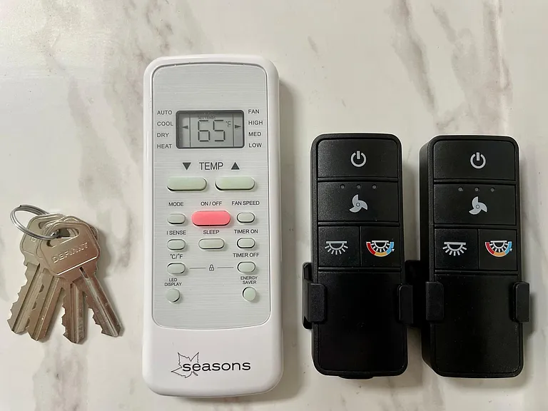 Remote Controls For A/C Unit and Ceiling Light Fans In Both Living Room & Dining Room
