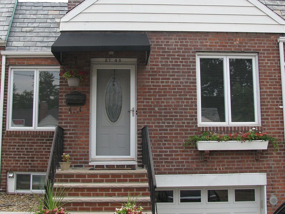 The front of the house, with private driveway and garage