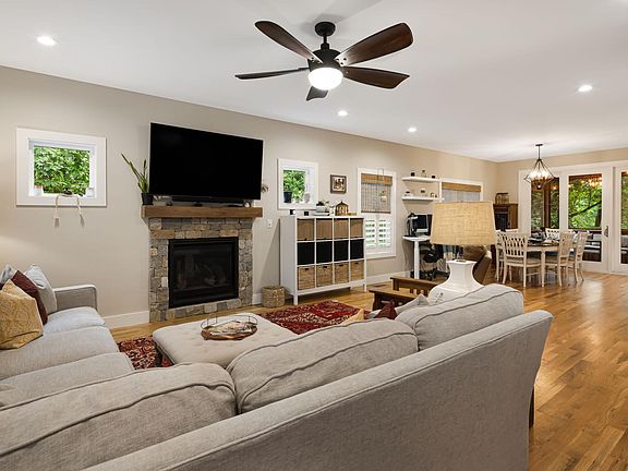 Open multi-purpose living space with gas fireplace and beautiful oak hardwood floors.