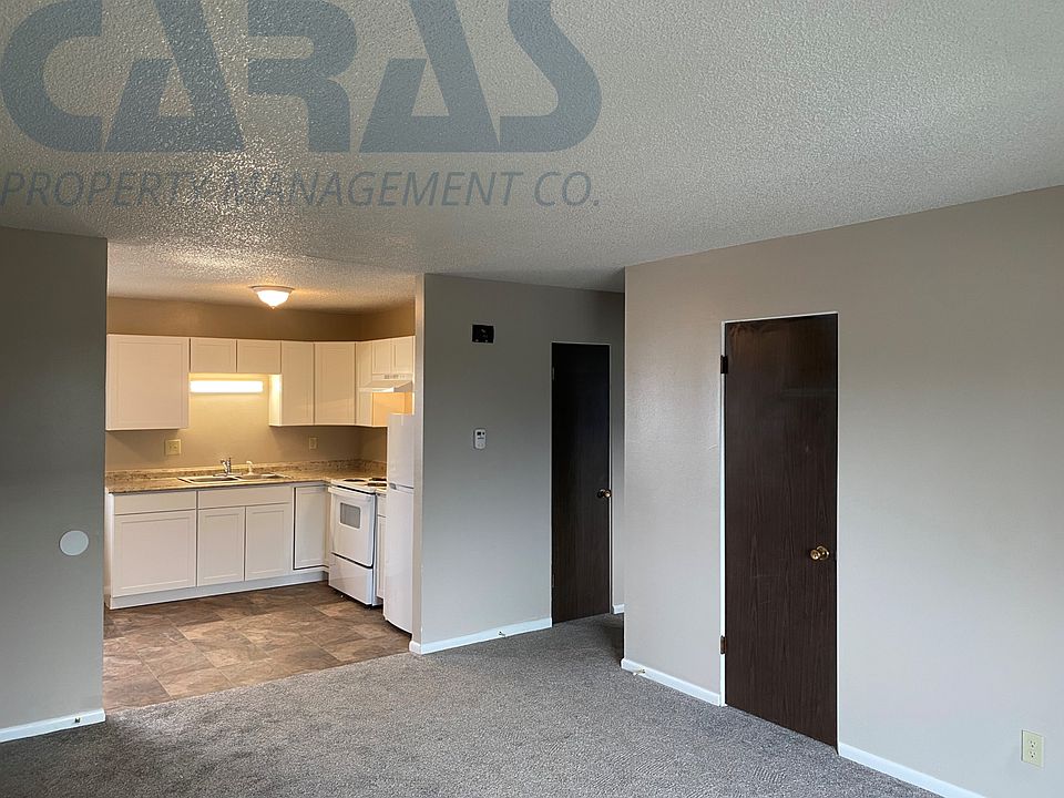 Kitchen and dining area opening to spacious living room.