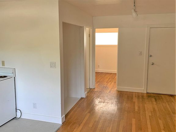 View of: Living/Dining Kitchen Towards Entry and Bedroom