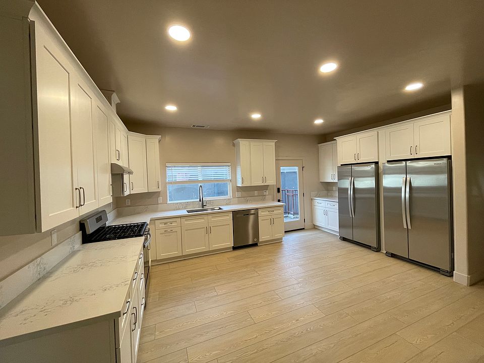 Brand-new appliances in this brand-new kitchen with double refrigerators, dishwasher, new flooring, new windows, and a digital entry.