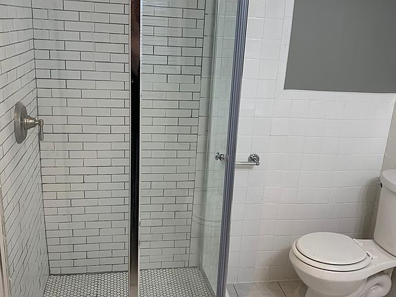 Clean, updated bathroom. New, shower, toilet, and vanity.