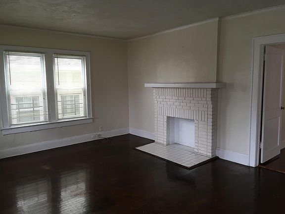 large living room with closed fireplace