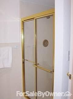 Large gold and tiled shower