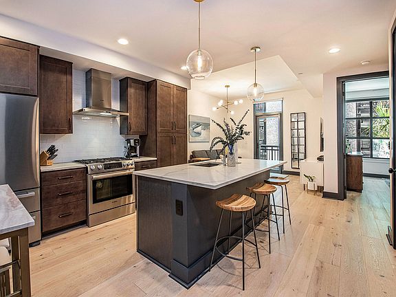 Large kitchen island with additional bar stool seating for three