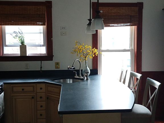 Kitchen island with corner sink & 3 stools.