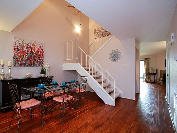 The paint has just recently updated to a desirable neutral color throughout! This dining area offers awesome high ceilings that look up toward the upstairs area giving an open and large feel.
