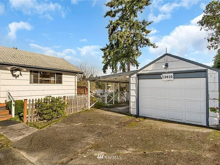 Covered carport and spacious driveway for parking