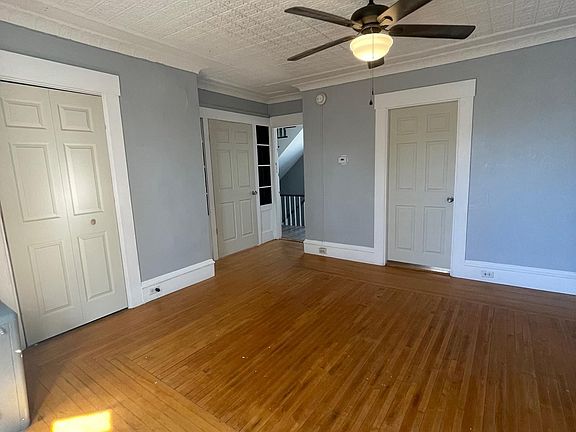 View of living room, bedroom doors and closet