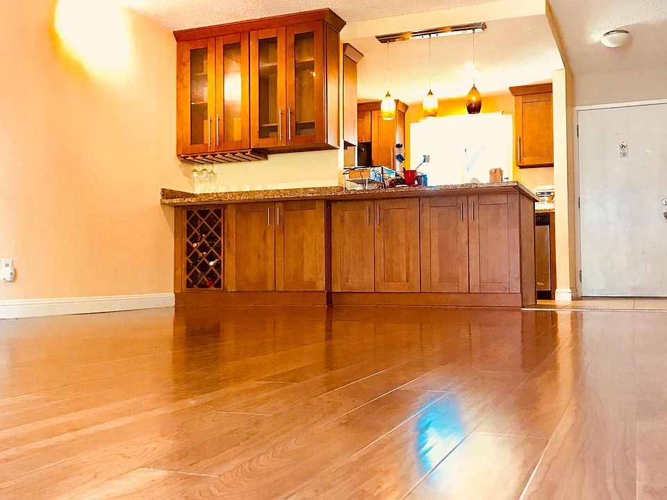Bar, wine rack, and plenty of storage in the kitchen. Cabinets on both sides