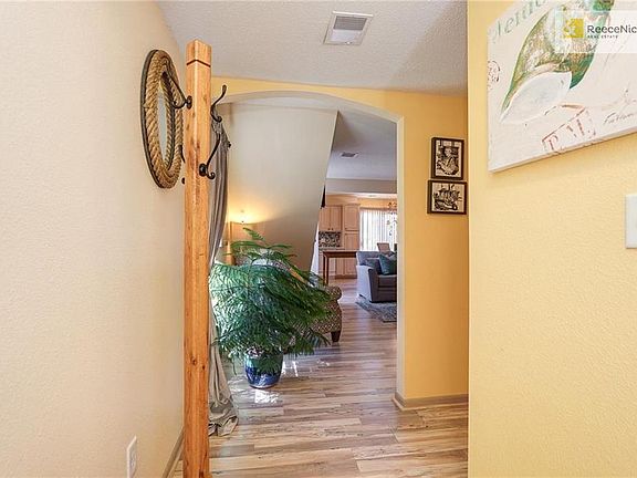 Bright and open entry way with 1/2 bath, closet.