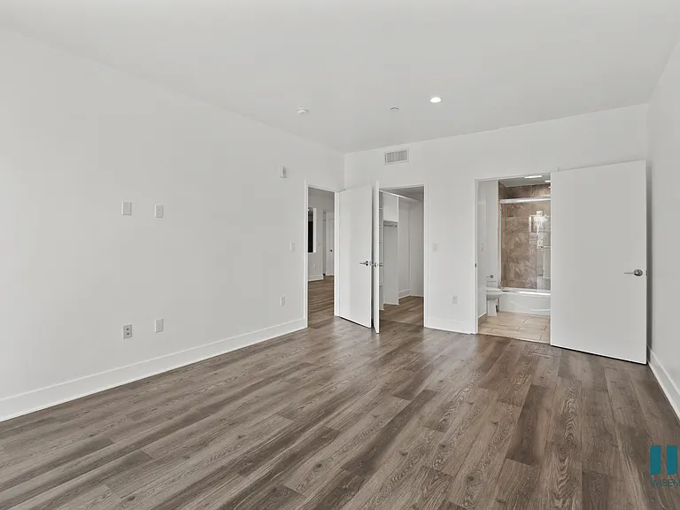 Bedroom with Bathroom, Walk-In Closet, and Vinyl Flooring