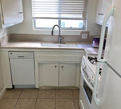 Remodeled kitchen with dishwasher, newer gas stove/oven, full size fridge, new designer kitchen faucet, new refinished countertop with newer kitchen window