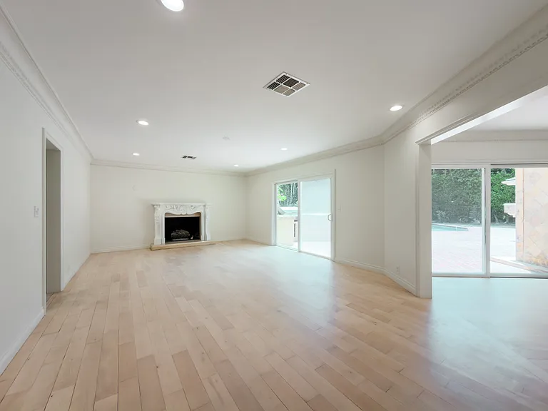 Open-concept living room with tall windows and crown molding fills this Beverly Hills luxury rental with natural light at 1094 Garden Lane, a premier 90210 lease.