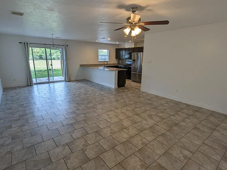 Open kitchen and living room, all tile flooring on first floor.