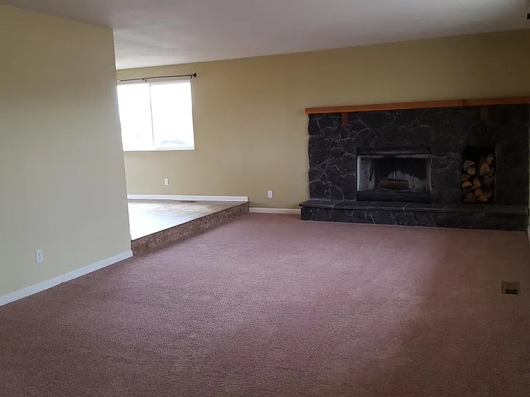 living room with wood burning fireplace