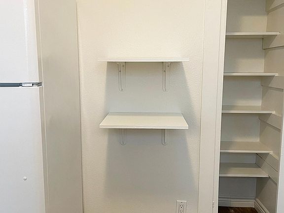 Additional kitchen shelving and pantry included.