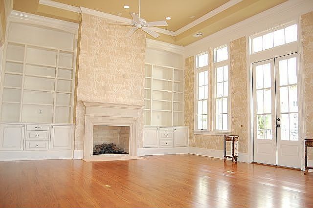Formal living room with veranda overlooking canal, tray ceiling, + built-ins.