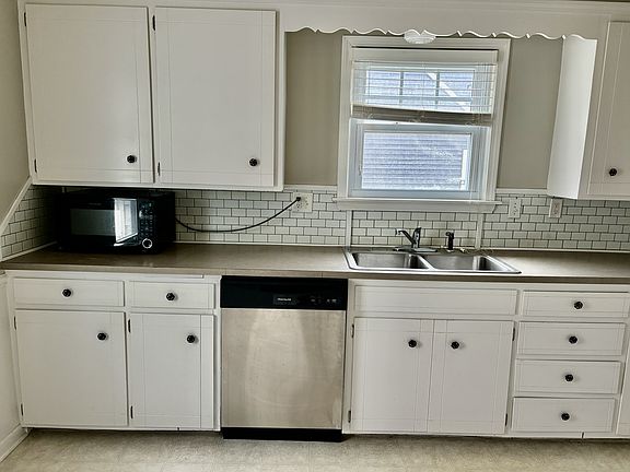 Recently redone kitchen with dishwasher, stove, fridge, and microwave.