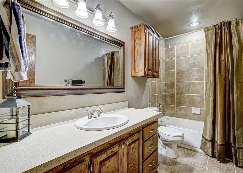 Main Bath with Custom Solid Oak Cabinety and Ceramic Flooring