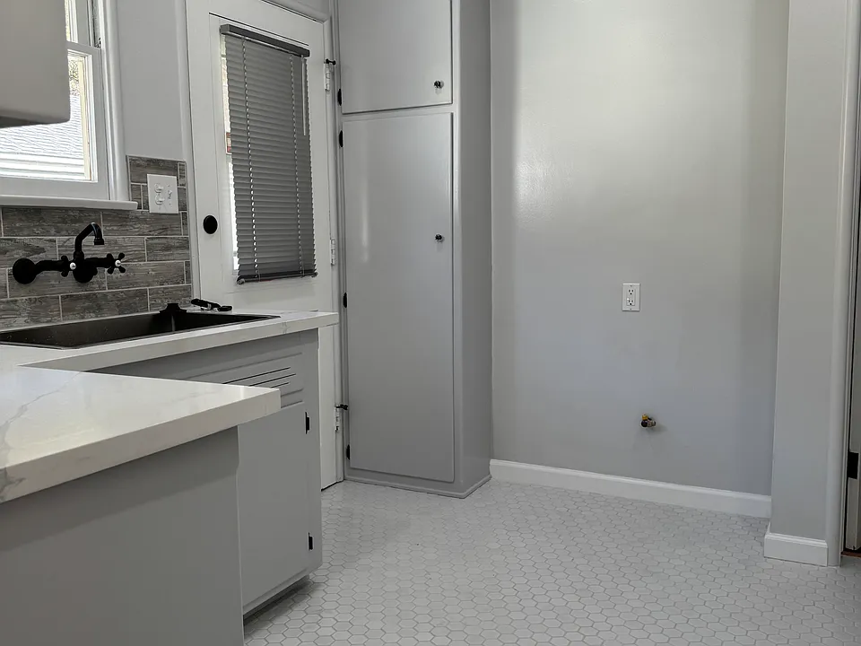 This unit has a backdoor entrance leading down to the garage