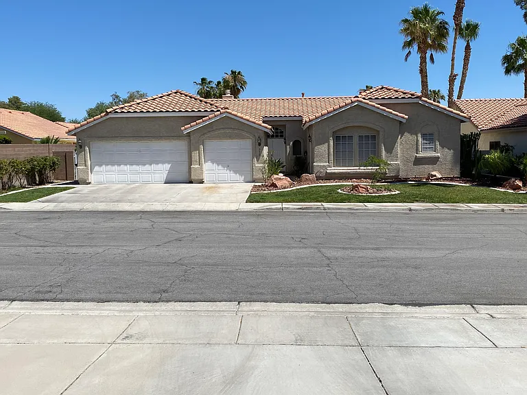 Single-story home with grass (rare, grandfathered in). Wide roads, sidewalks, mature landscaping, decorative rock. Solar screens to keep bills low. Three-car garage with attic storage throughout the home. Landscaping and pool maintenance included in rent.