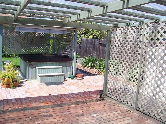 covered brick patio with spa