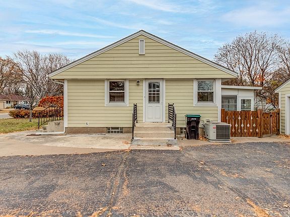 Side entrance, parking pad on either side of driveway