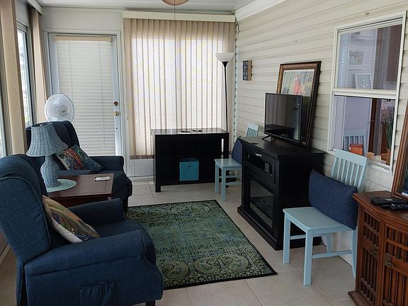 Florida room with electric fireplace, desk and storage