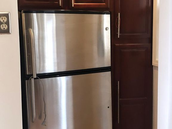 Refrigerator and pantry area in kitchen