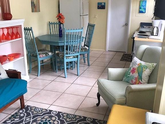 Walking in the door the area is open to the living room, dining room and kitchen. The bedroom is on your left (can't see it in this pic). Beautiful and welcoming coastal furnishings.