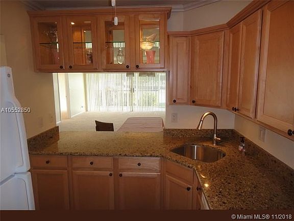 Renovated kitchen includes granite and self-closing cabinets.