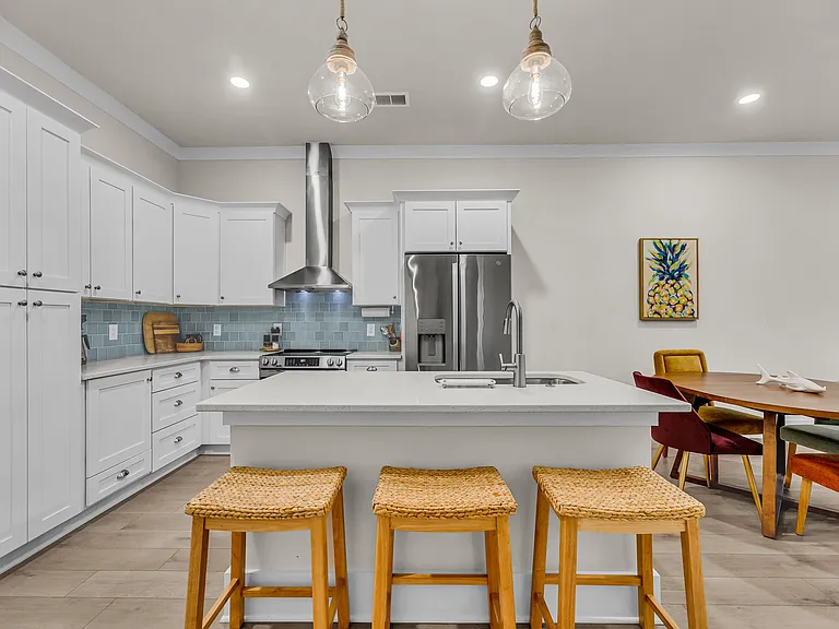Island seats 3 and includes stainless sink with garbage disposal and dishwasher