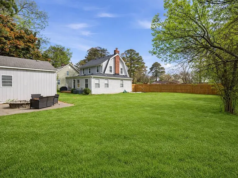 The huge backyard includes a deck and grill. Perfect for kids or pets that want to run around.